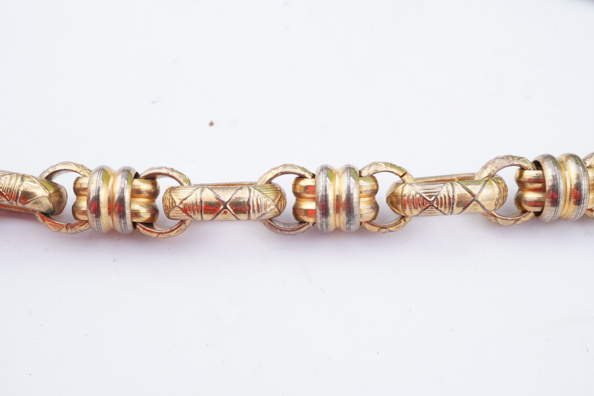 A group of gilt metal/pinchbeck jewels, 19th and early 20th century, comprising: a brooch of knotted design; two gate bracelets; a fancy link bracelet; an open-faced pocket watch; two oval panel brooches, and two watch c